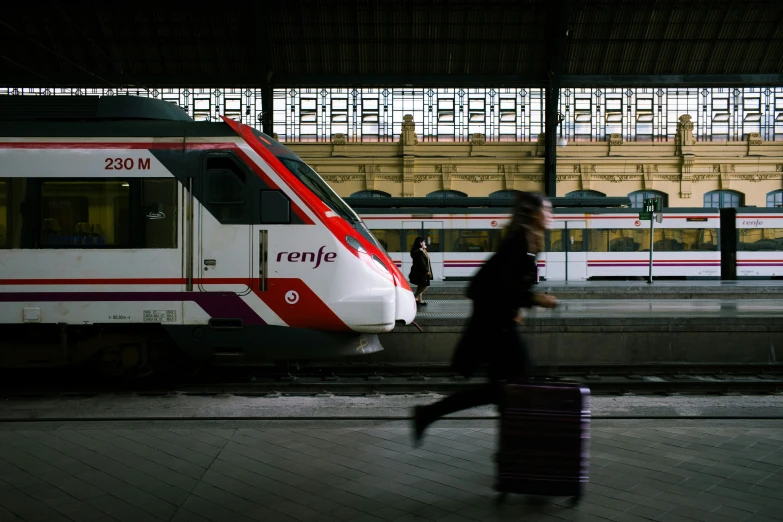 a passenger train pulling into a train station