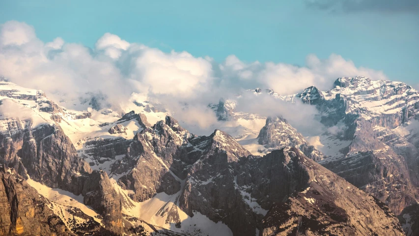 the clouds roll through the mountains in this scenic scene