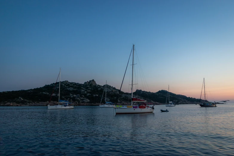 boats sitting on the water in a large body of water