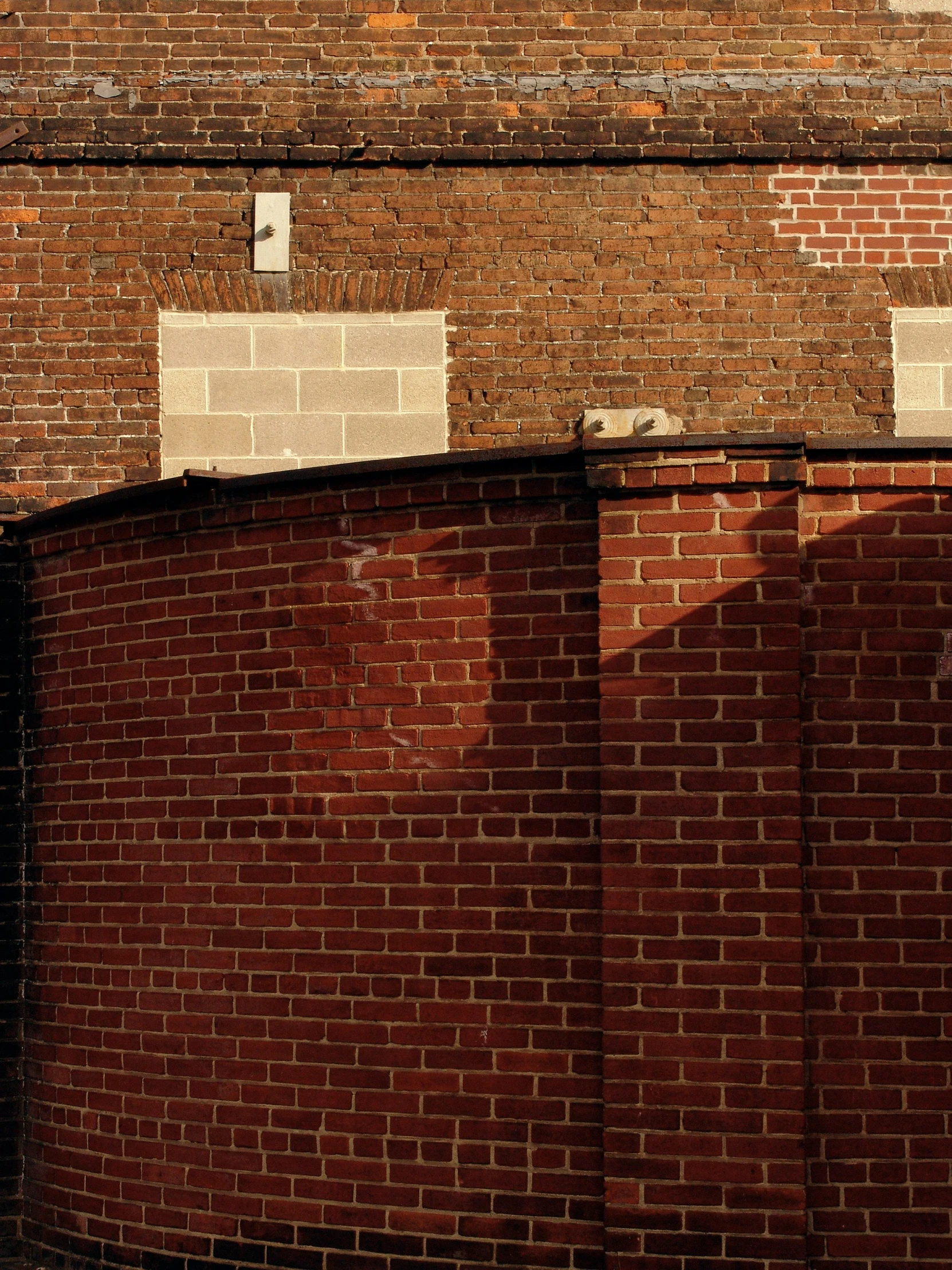 a man riding a skateboard on the side of a brick wall