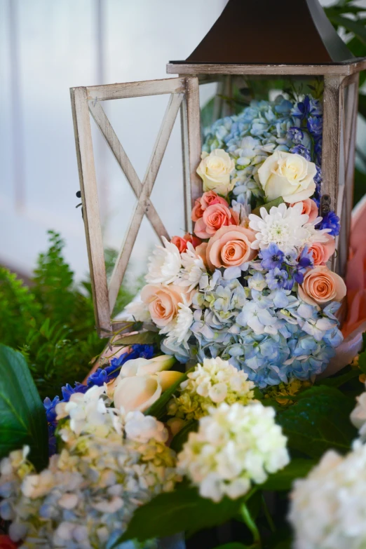 a bunch of flowers that are inside of a lantern