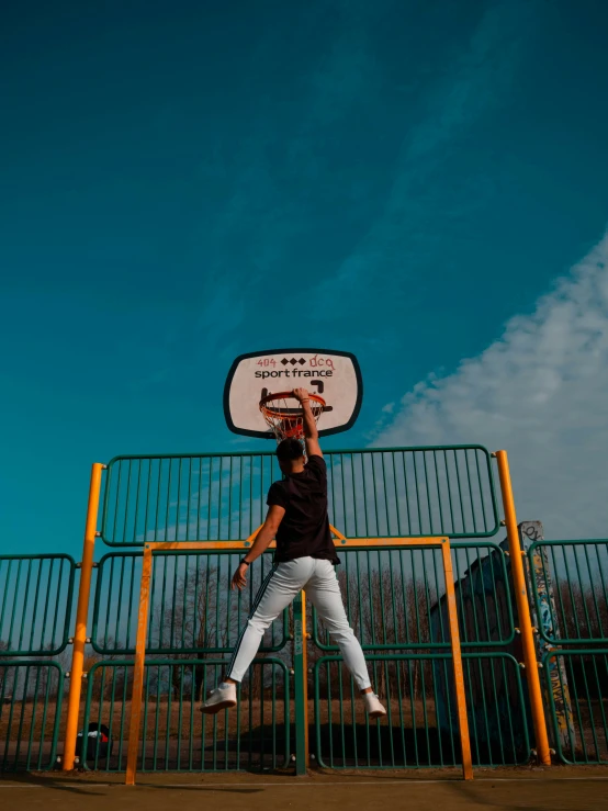 a man standing underneath a basketball hoop on a basketball court