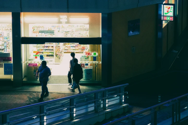 two people in front of a store at night