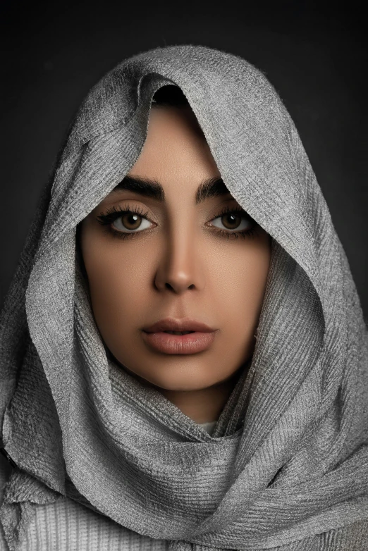 a woman wearing a silver scarf over her head