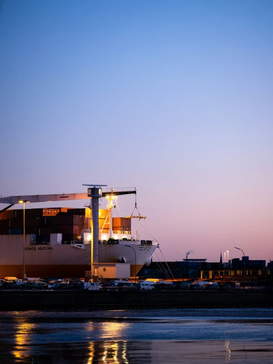 a large ship at the dock with several lights