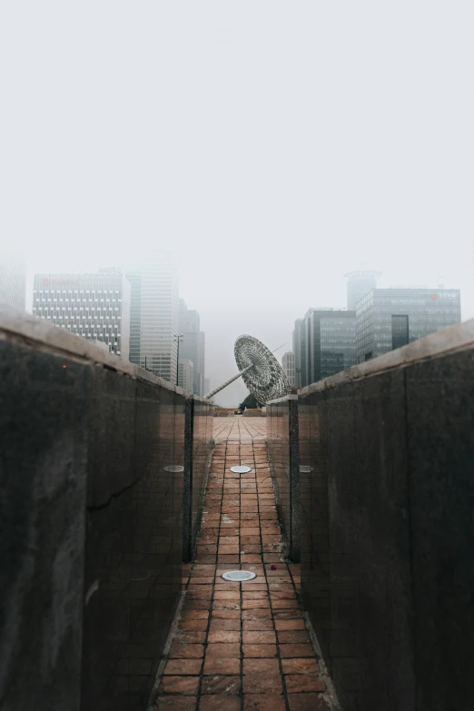 a walkway that has two umbrellas on top