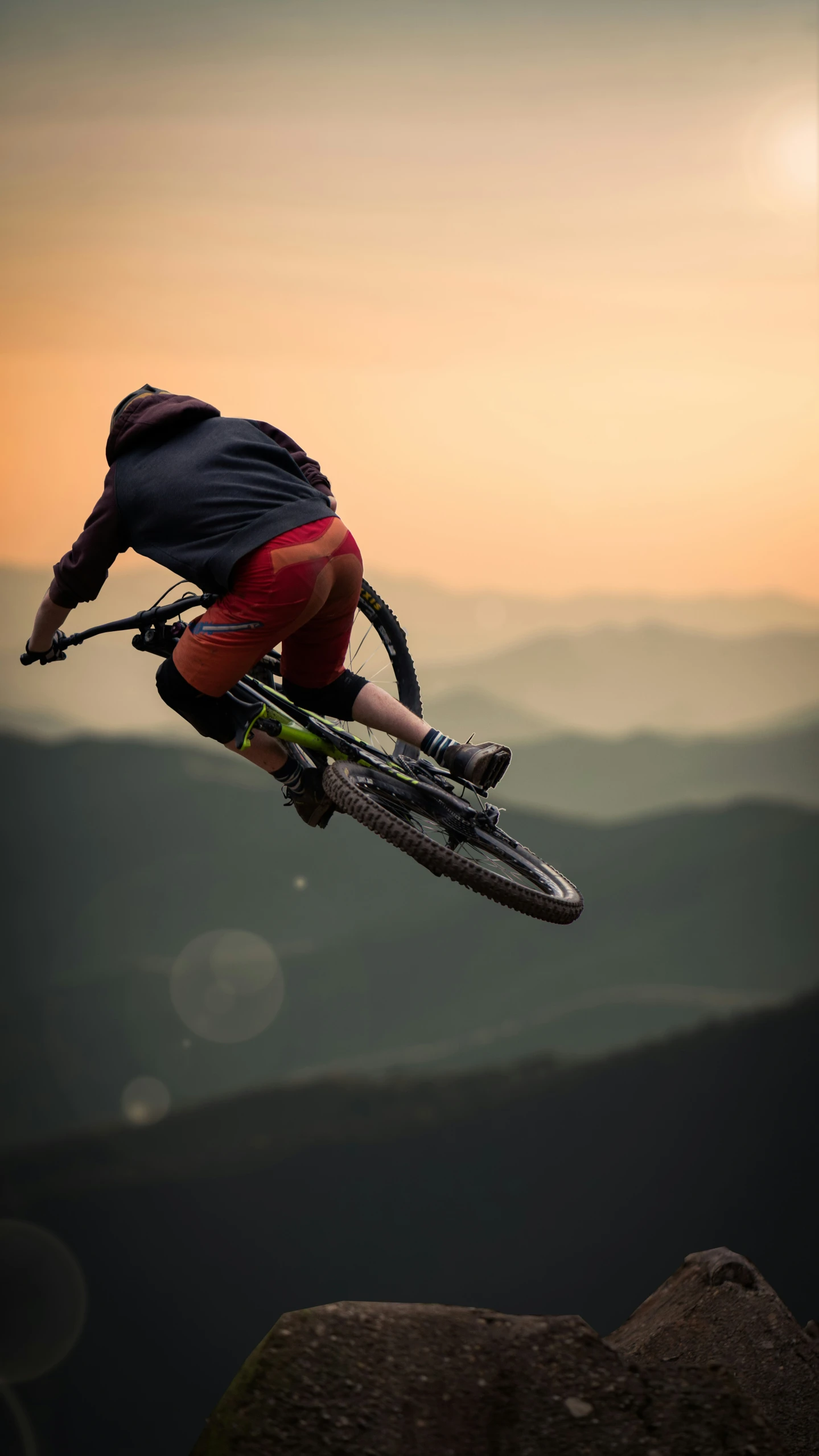 a man on a bike doing tricks in the air