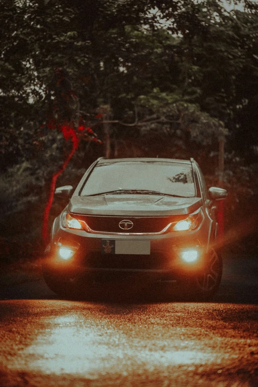 car driving down the street in front of some trees