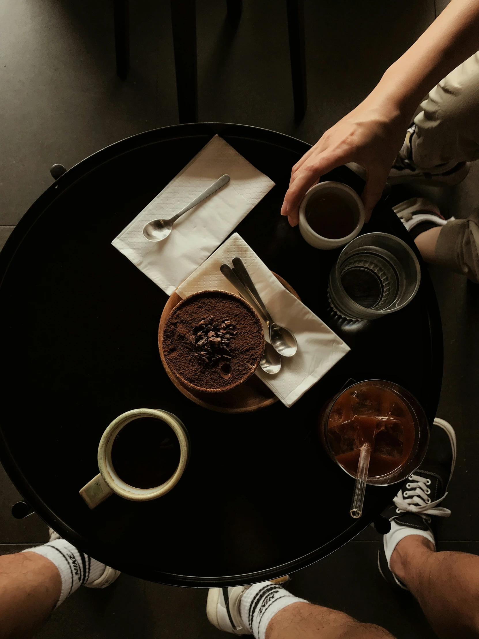 the three persons are getting ready to drink their coffee