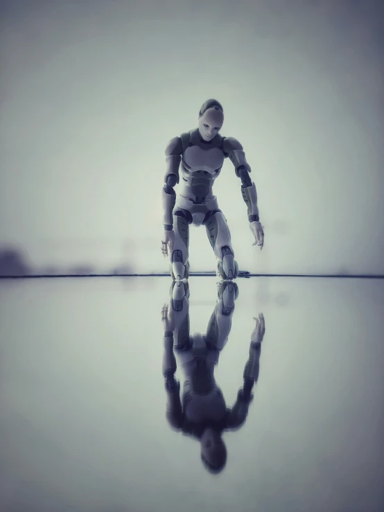 a futuristic white robot walking across a shiny surface