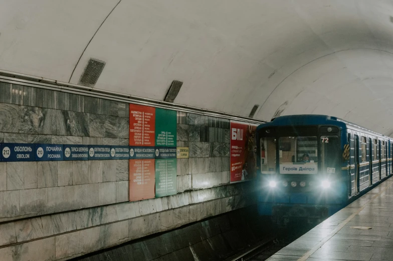 a subway train coming into the station in the rain