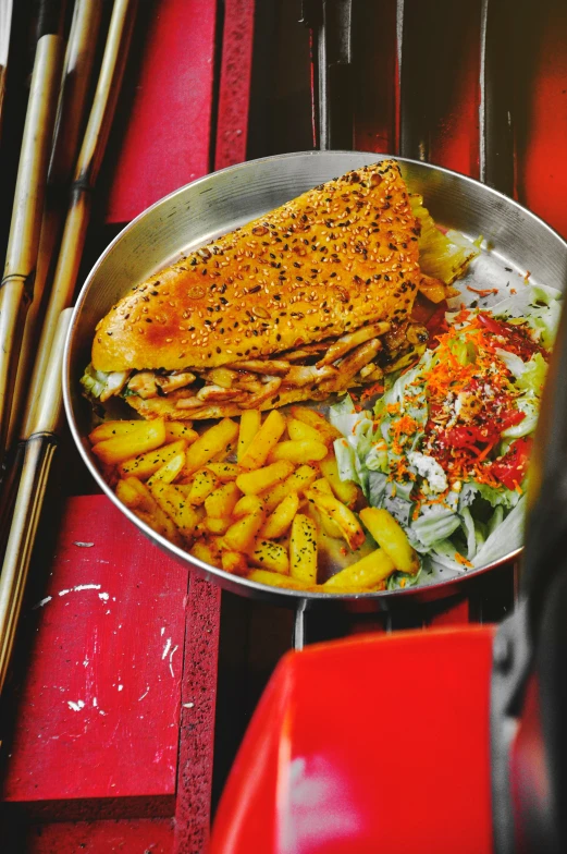 the large fish has french fries on it and red place mat