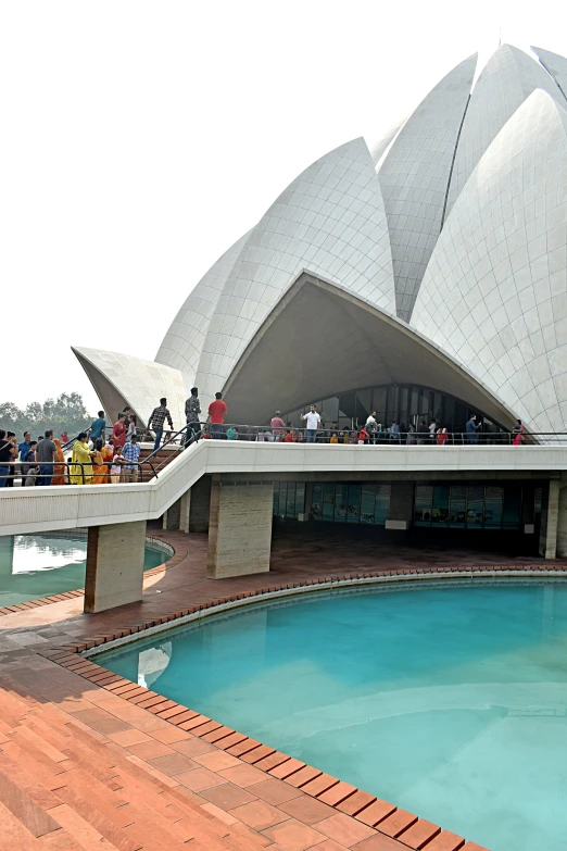 a large building that has a pool in front