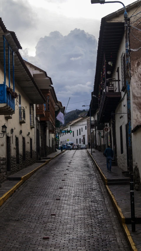 a cobblestone street and buildings on the sides of it