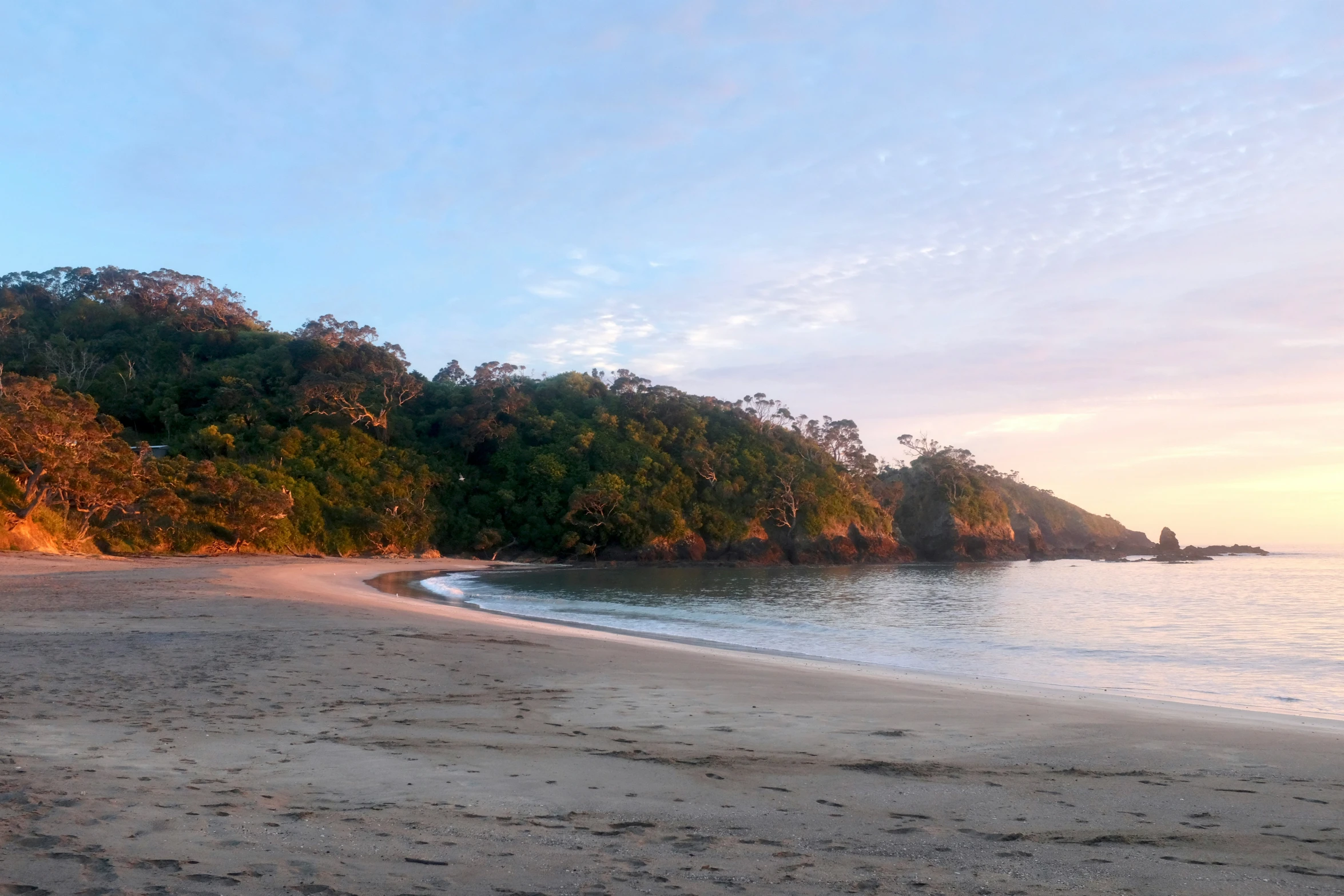 a small beach is next to the water