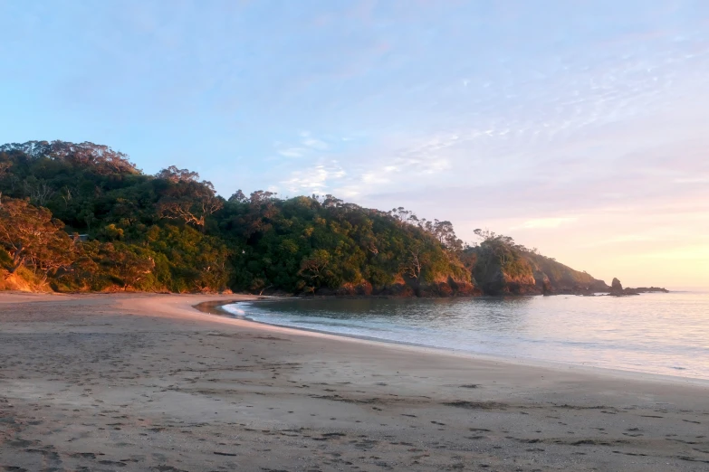 a small beach is next to the water