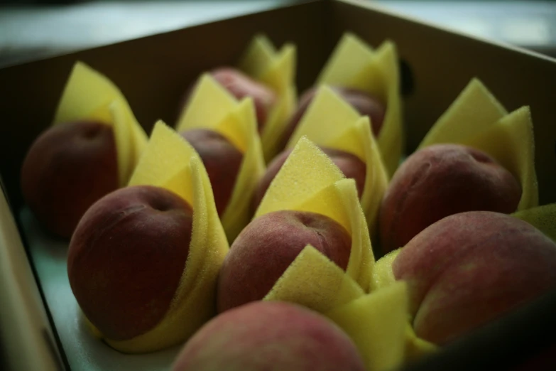 apples in a box with the fruit tape peeled off