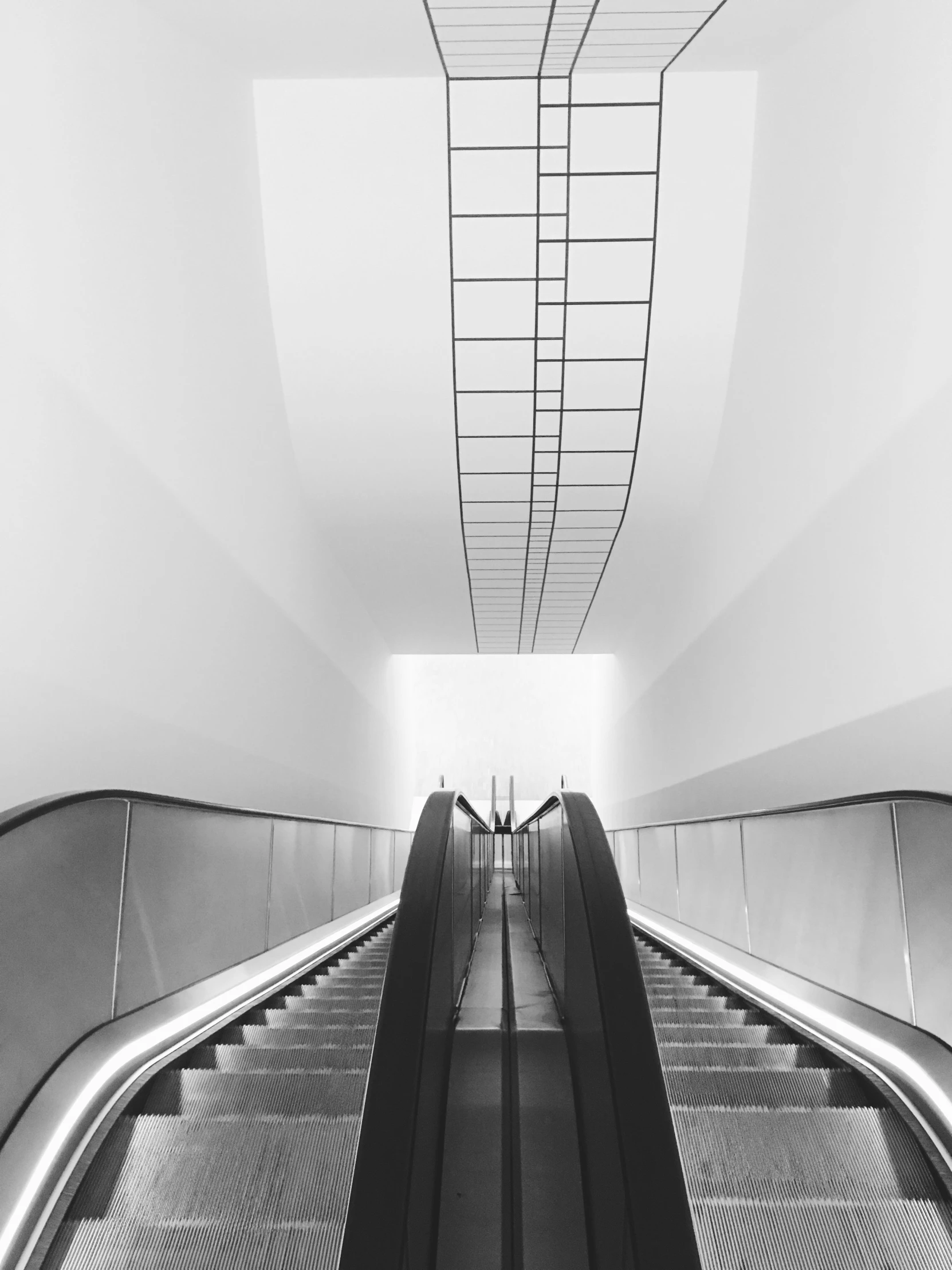 a group of escalators that are above an area