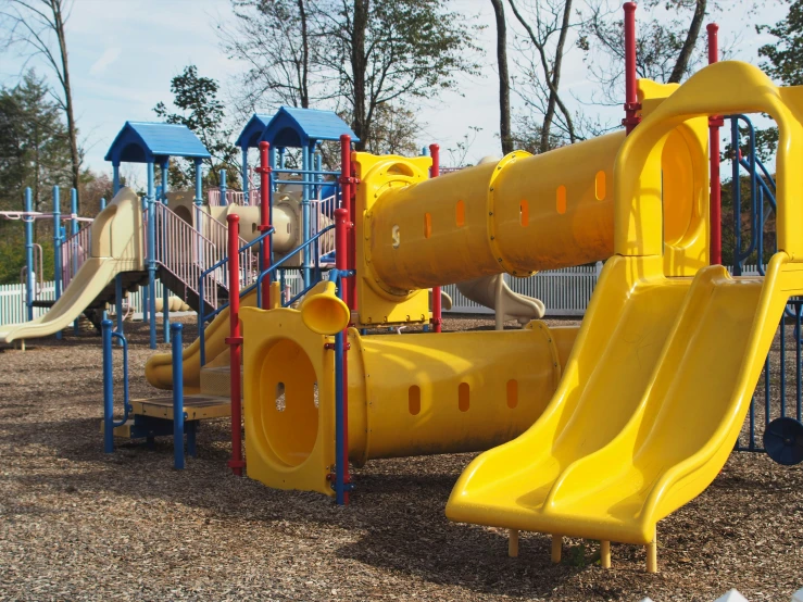 a very colorful and empty playground with a large slide