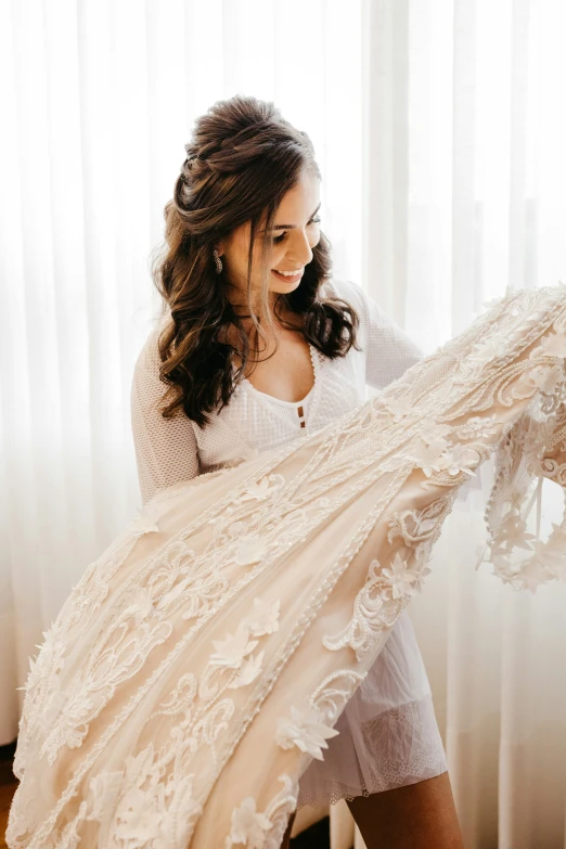 a woman in white dress holding a scarf