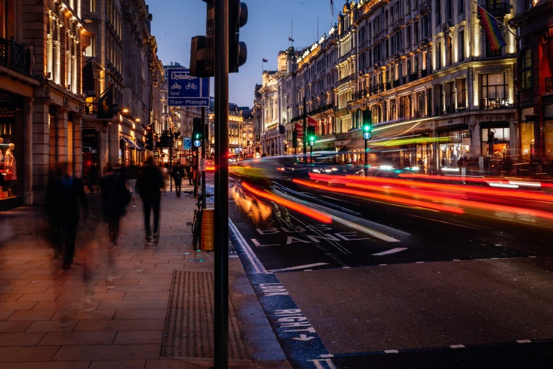 two people walking down a busy city sidewalk