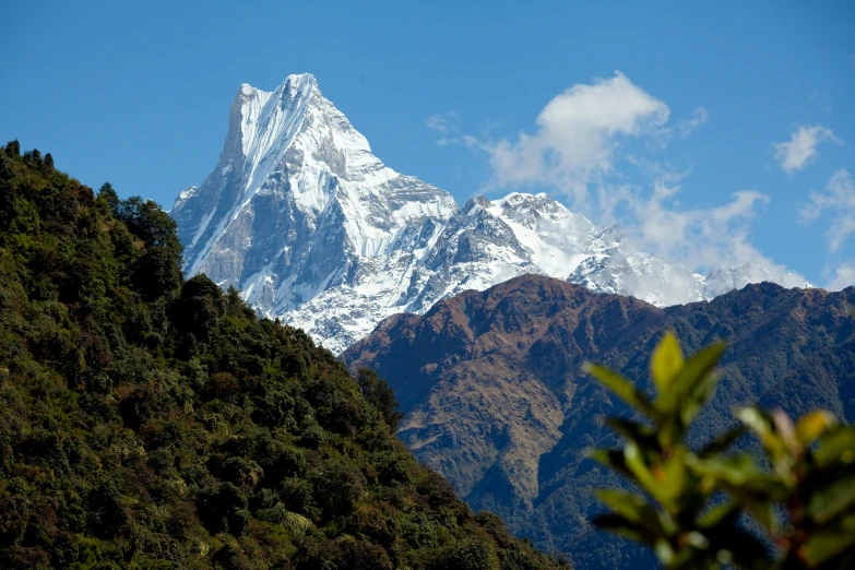 the mountain covered in a snow - capped top is seen