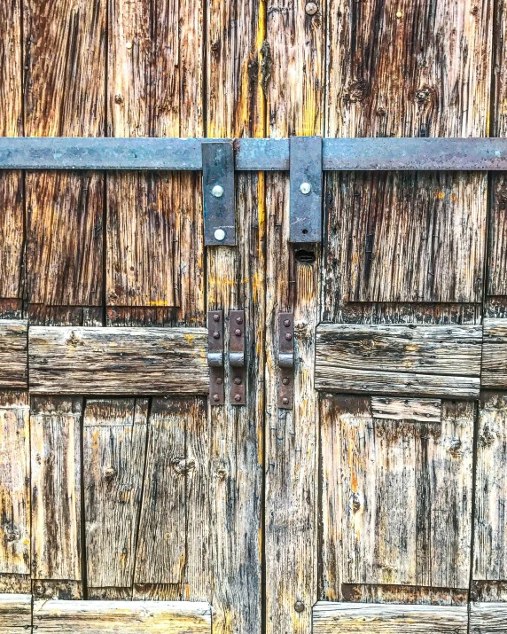 an old wooden door with metal latch