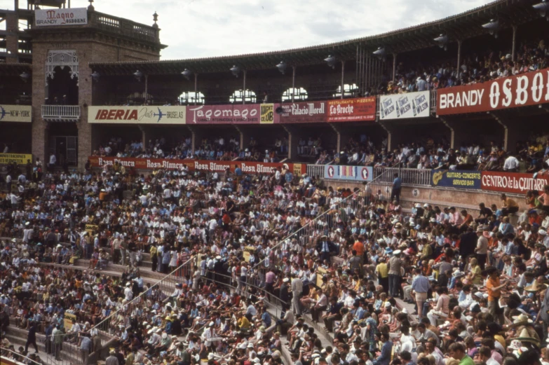 many people are sitting in the stands at a baseball game