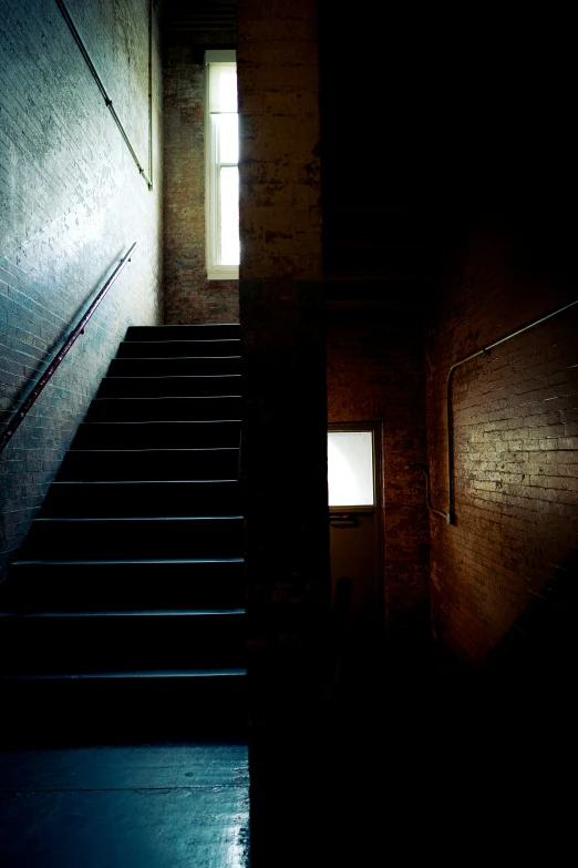 stairs in a dimly lit room with a window