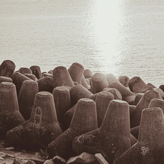 large rocks sticking out of the ground near the ocean