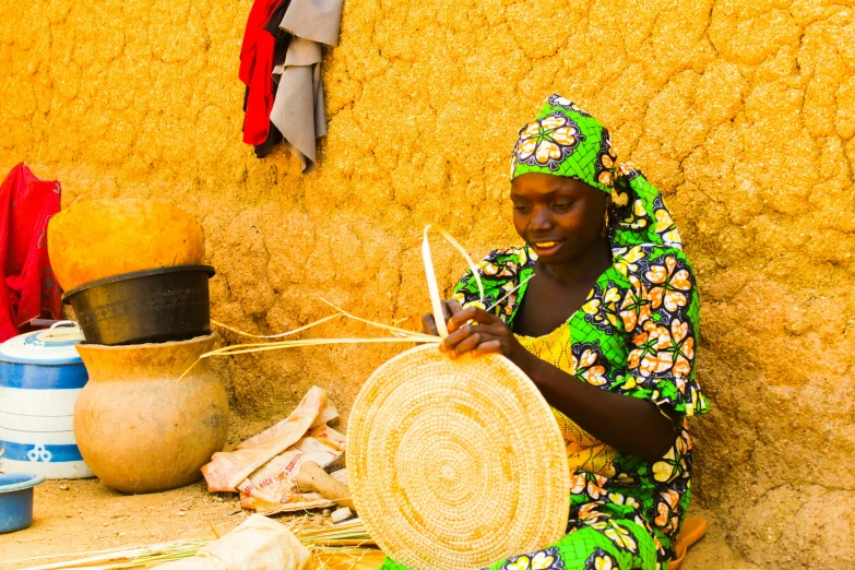 a woman sitting down and holding a basket