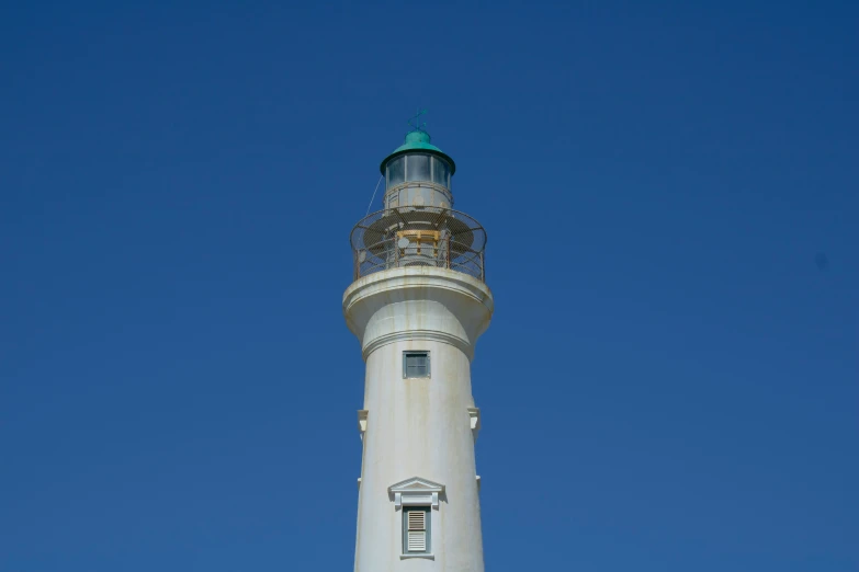 a lighthouse with white and yellow painted on it
