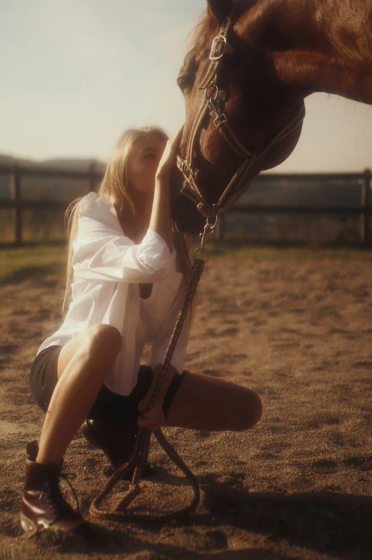 a girl is petting a horse that is standing next to her