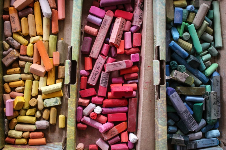 several boxes of different colored chalks lined up