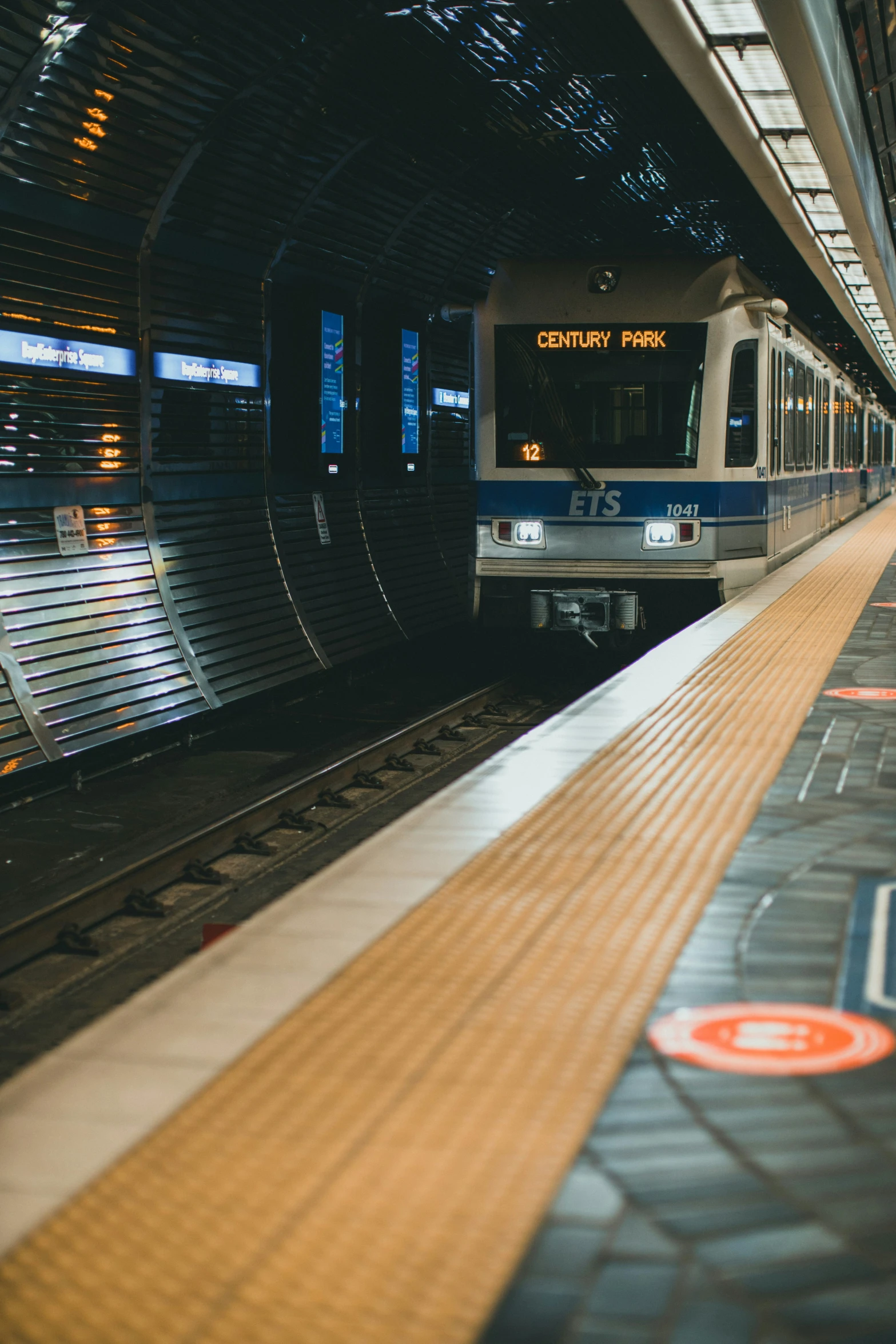 a white and blue train pulling into a station