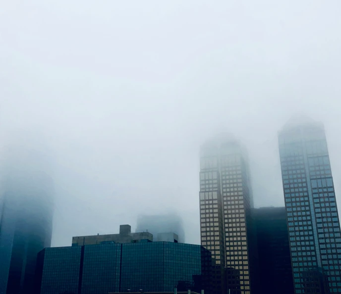 the city skyline is surrounded by smoggy fog