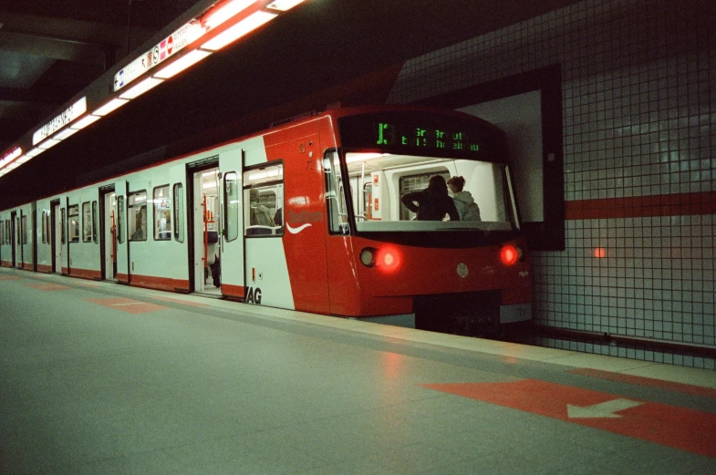 the red train has stopped in a subway car