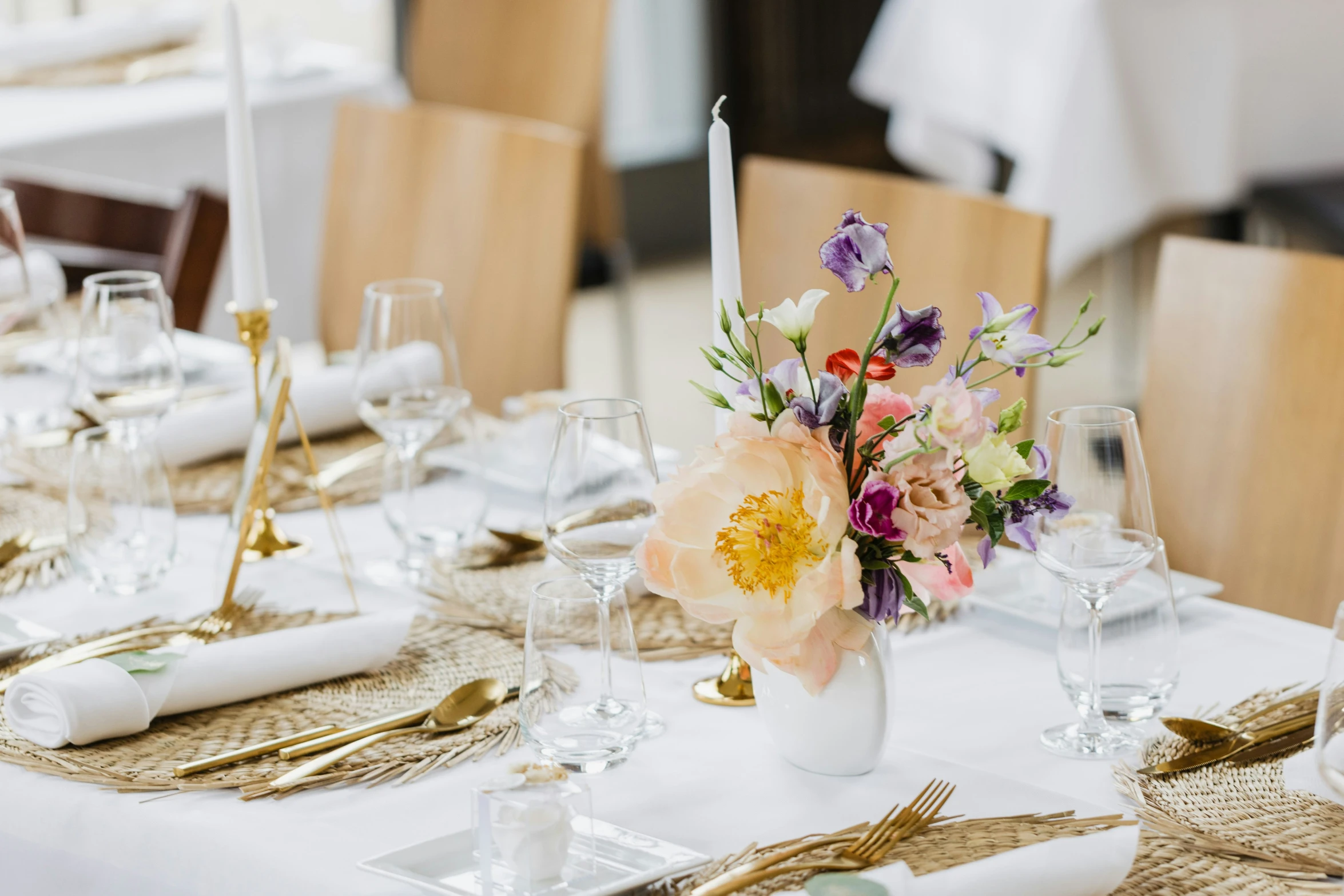 a bunch of place settings set on top of a dining table