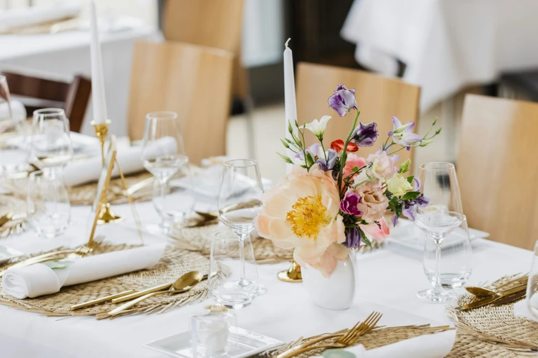 a bunch of place settings set on top of a dining table