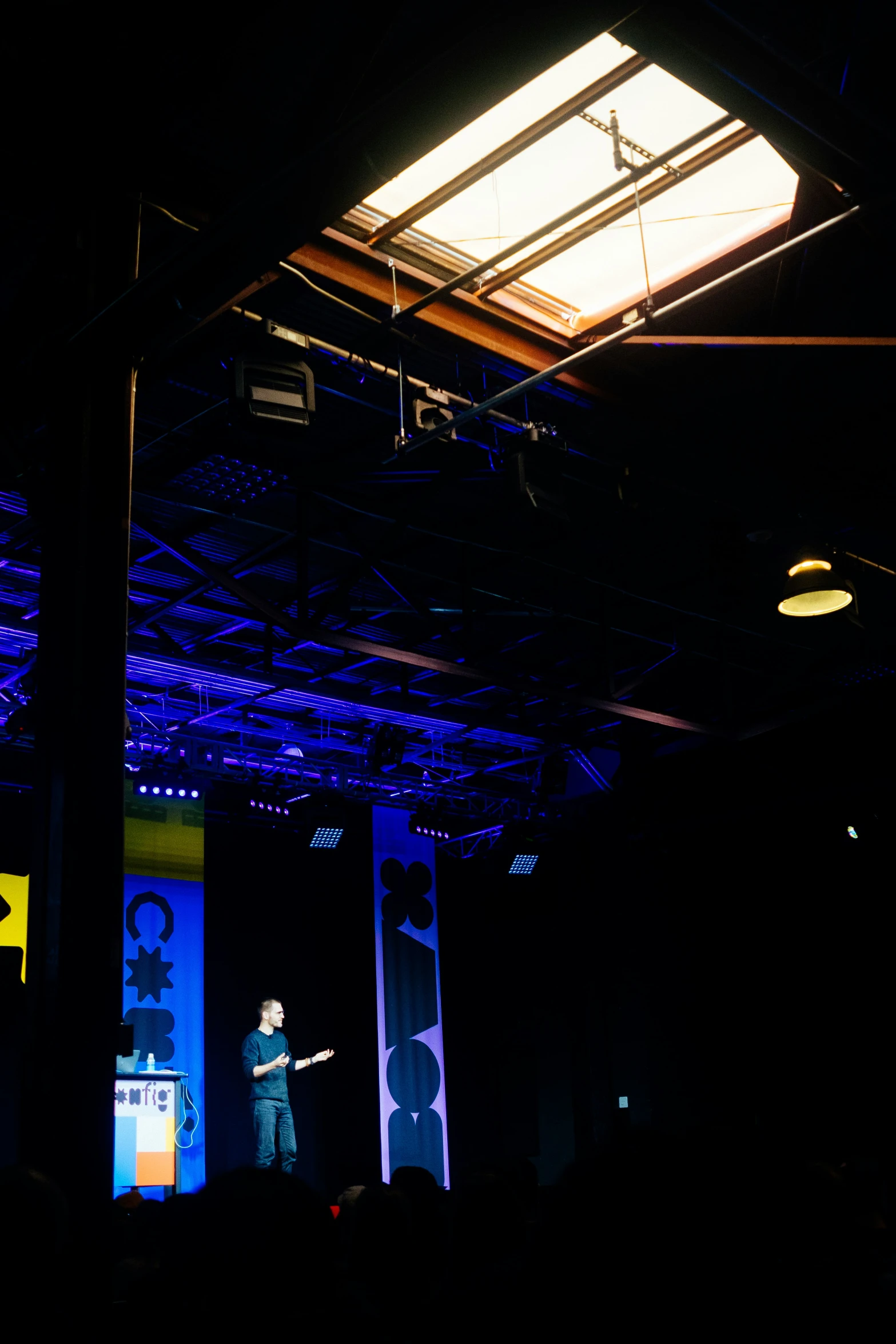 a stage with speakers at an event at night