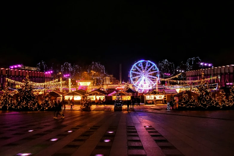 a carnival with lit up trees and lights