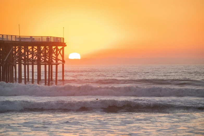 a pier that is sitting in the middle of the ocean