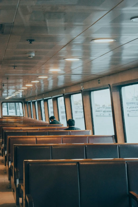 the inside of a dining car is seen through the large windows