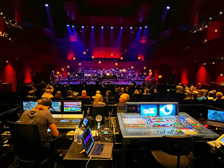 a large room with many monitors and a couple people