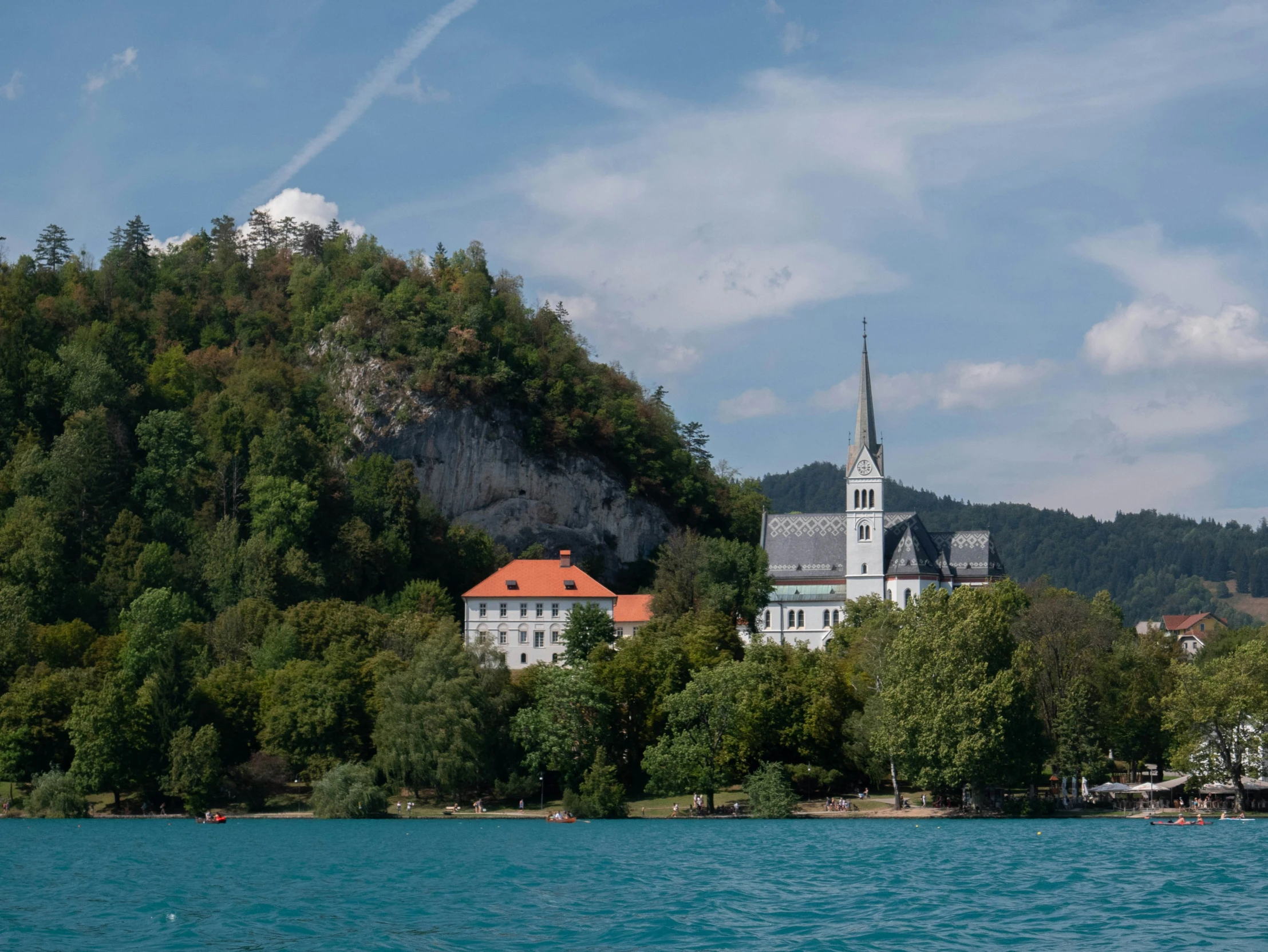 a church on top of a hill above water