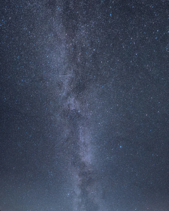 a starr filled sky at night with an rv parked under it