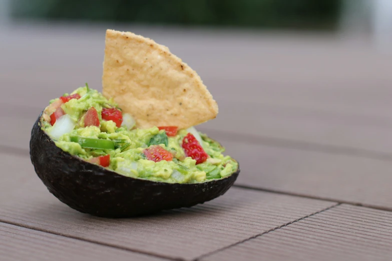 some sort of dish with guacamole and strawberries