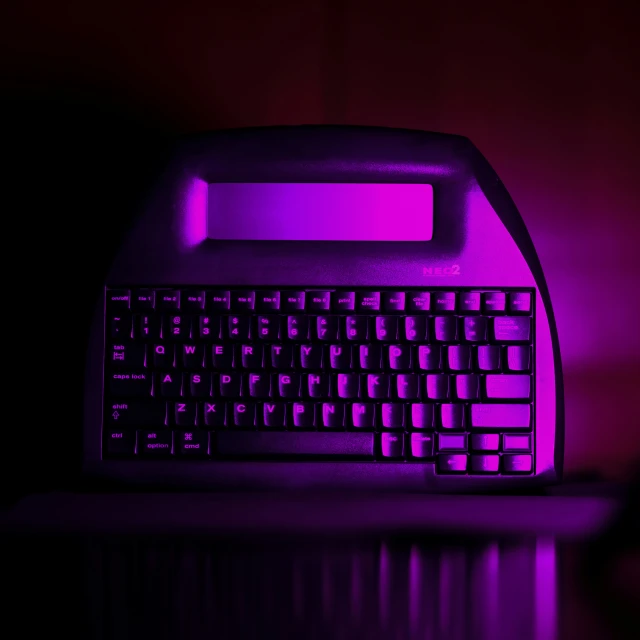 a computer keyboard with a glowing purple background