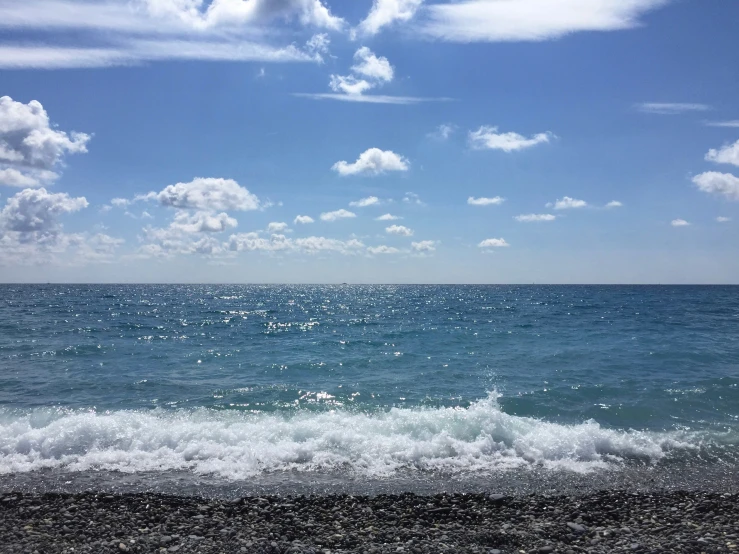 the sky is covered in a layer of clouds above the ocean