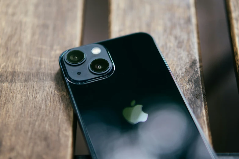 an iphone with camera attached to the side sits on a table